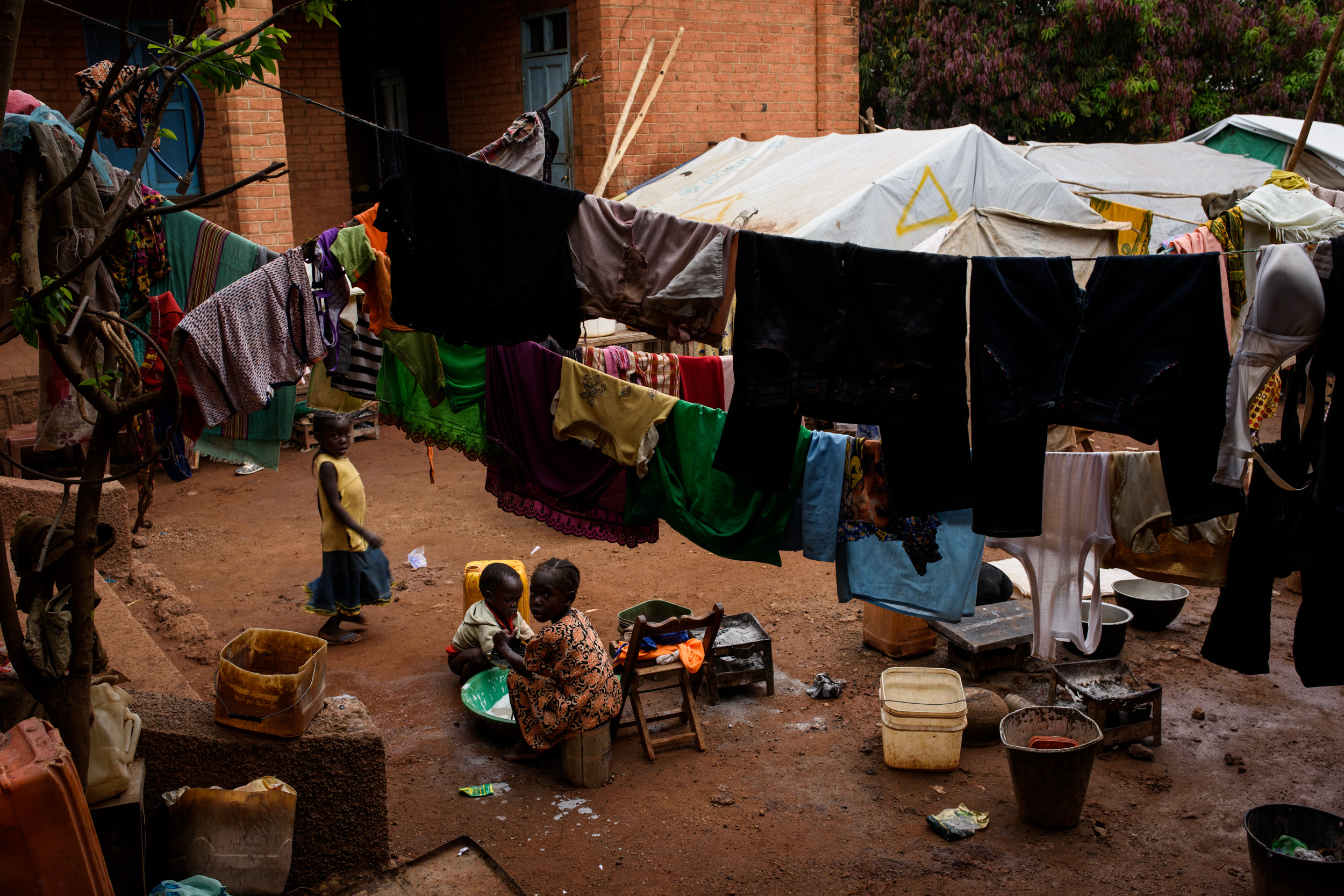 A young girl washes clothes in the grounds of St. Mary's cathedral in Wau, South Sudan, on June 15, 2017. Some 13,000 people live in the cathedral grounds, having taken refuge here after violence broke out a year ago.
Photo by Phil Hatcher-Moore -