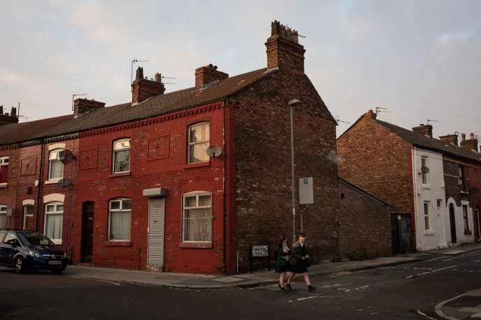 Two girls walk through typically working-class terraced housing in the neighbourhood of Walton in Liverpool, England, on November 22, 2018. Walton is considered one of the Labour party's safest seats in the country, but is described as a deprived area. It was hit hard during the 1980s and exacerbated by the economic crash of 2008. The constituency voted to leave the European Union in the 2016 referendum, bucking the trend of the city as a whole, which voted to remain.