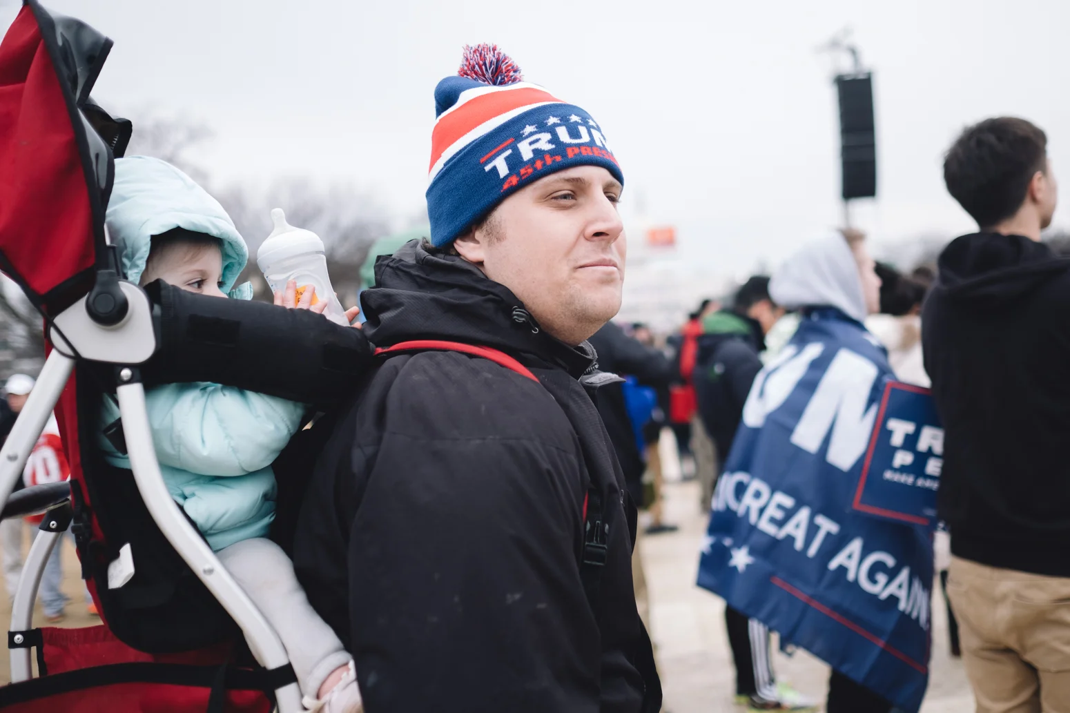 Ryan Gaston of Atlanta, Georgia said concerning the Health Care Law (ACA) "I don't want to see him abolish it completely". Ryan was joins on the National Mall with his wife and two children Clara (10 months) pictured and Fiona (2 years old).
