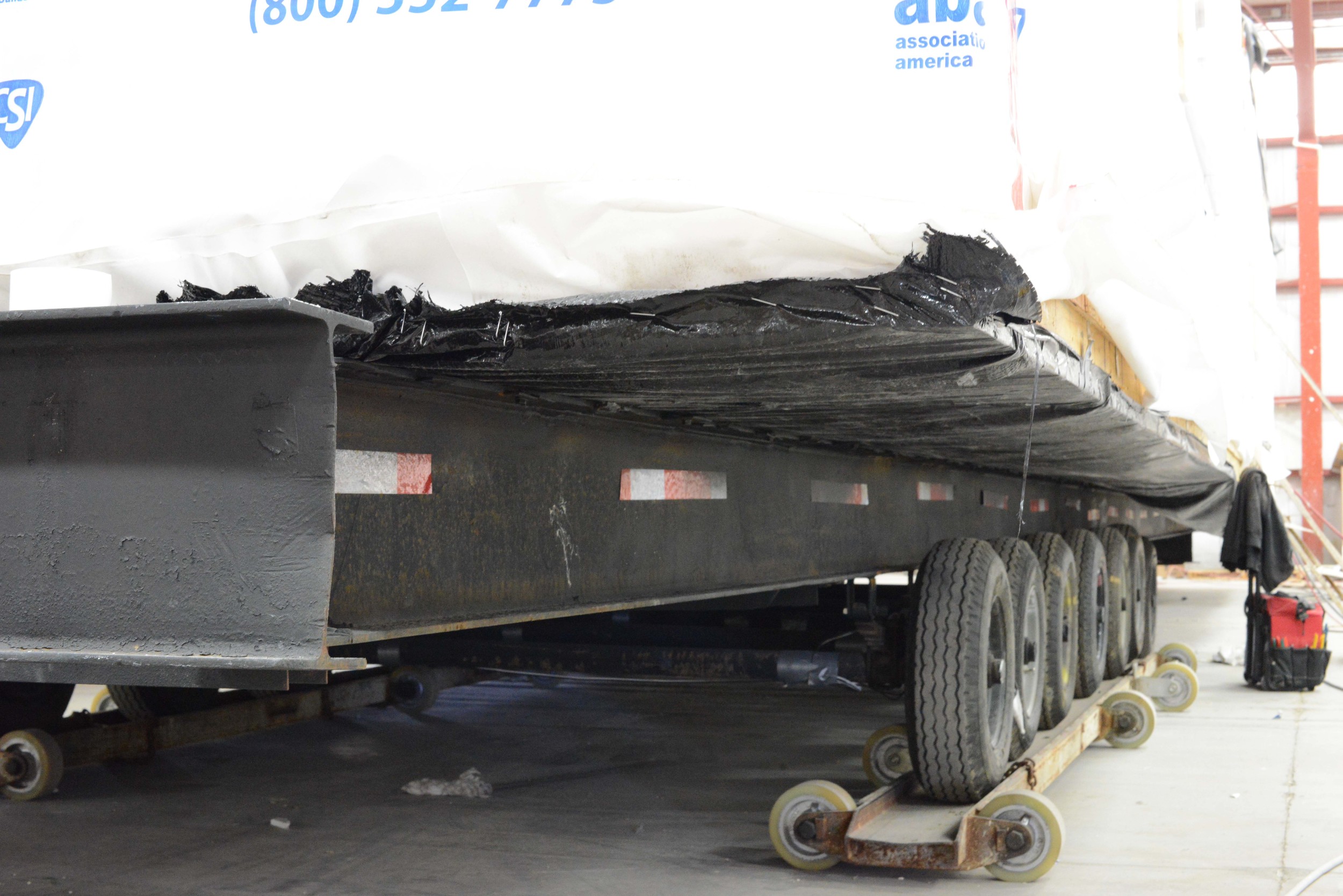 Given the layout of the factory floor, the entire trailer is driven up onto skids so the module can travel perpendicularly on the factory floor.
