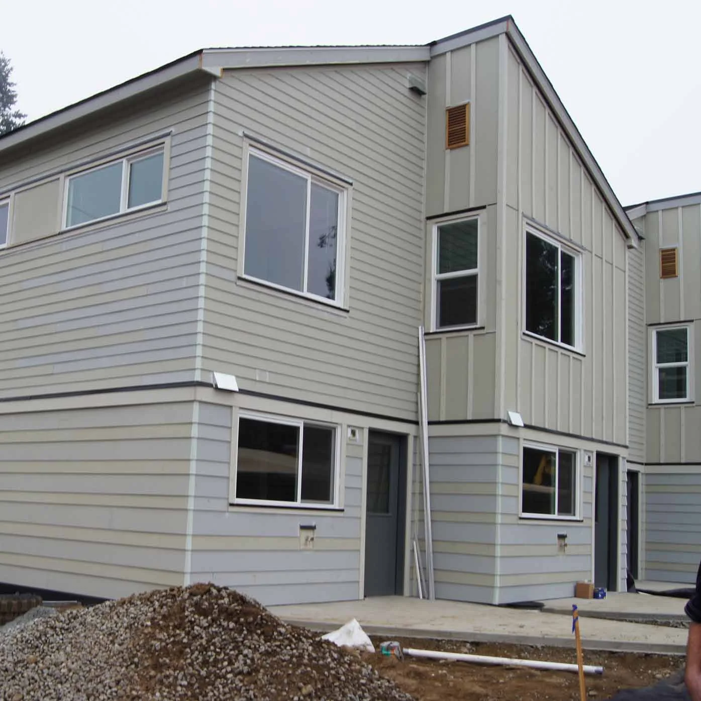 Finishing touches such as awnings, gutters, and downspouts are installed.