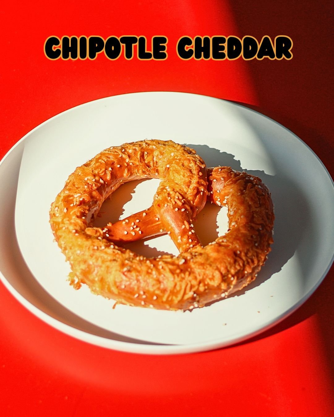 🔥 Bring the Heat Before the Storm! ❄️

Our Chipotle Cheddar Pretzel is the spicy comfort you need before the snow rolls in. We mix smoky chipotles in adobo sauce right into our dough and top it with melty cheddar cheese before baking it to golden pe