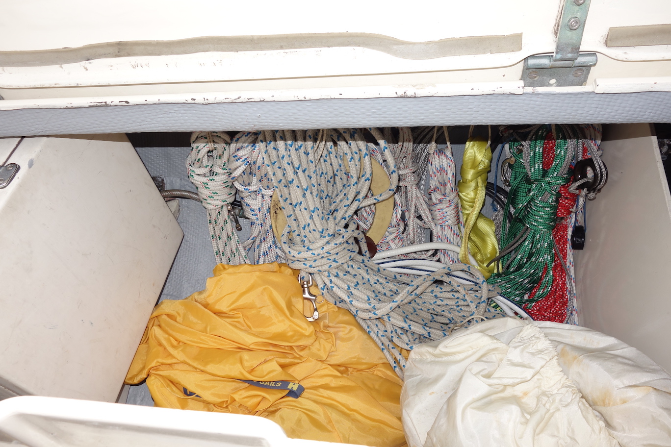  Sail storage in port cockpit locker. Note the very organized line storage on hooks outboard. 