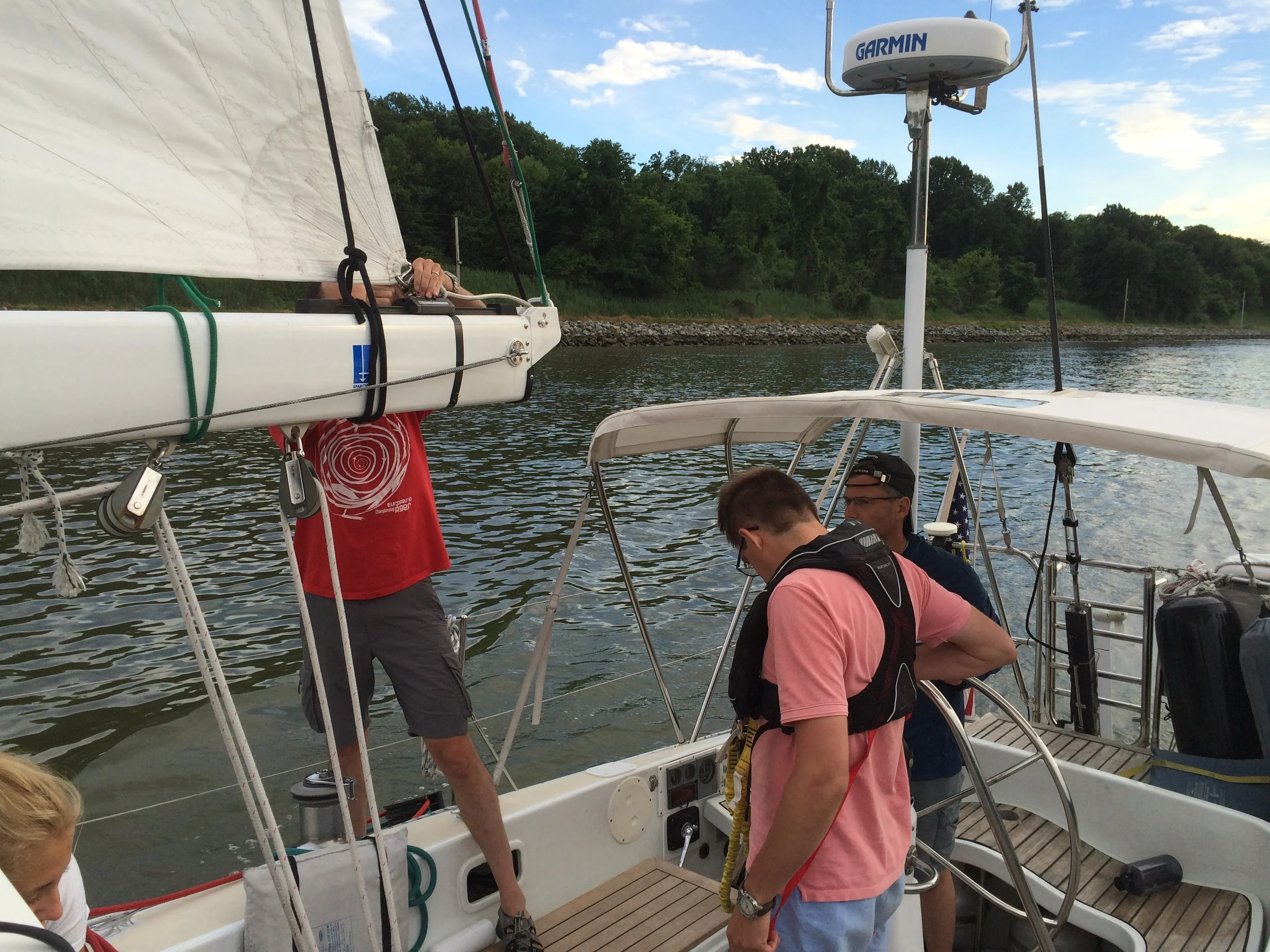 Bruce and the crew fixing the mainsail outhaul shackle in the C&D Canal.