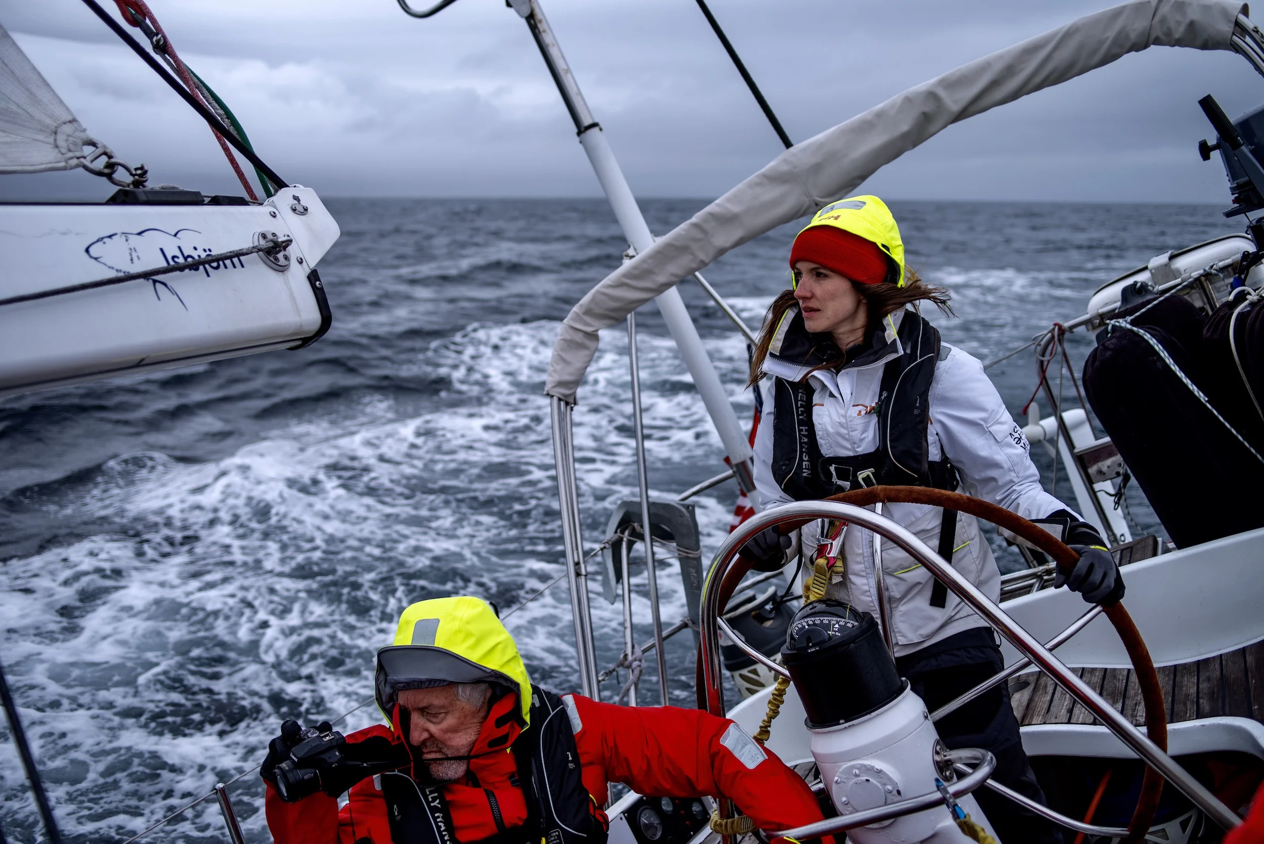 Laura at the helm while Tom films Isbjorn charging upwind in the Vestfjord.