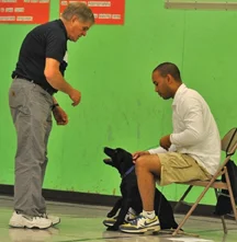 Harold Hansen helping a student at his "Heeling Free" Dog School in Eugene
