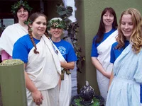 Volunteers don Togas as they greet and help the public throughout the day.