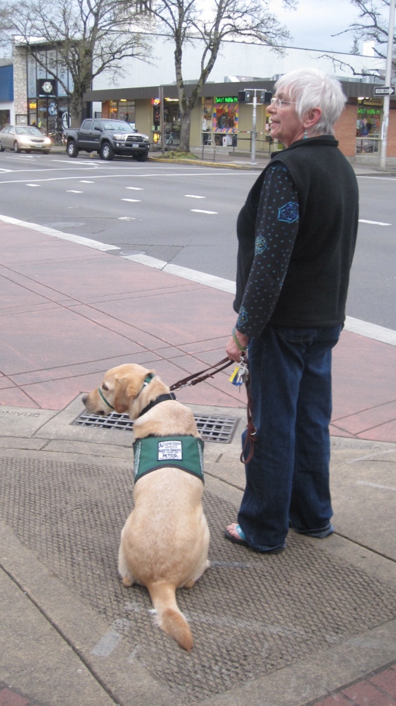 Pam and Ion waiting to cross a busy street in downtown Eugene.