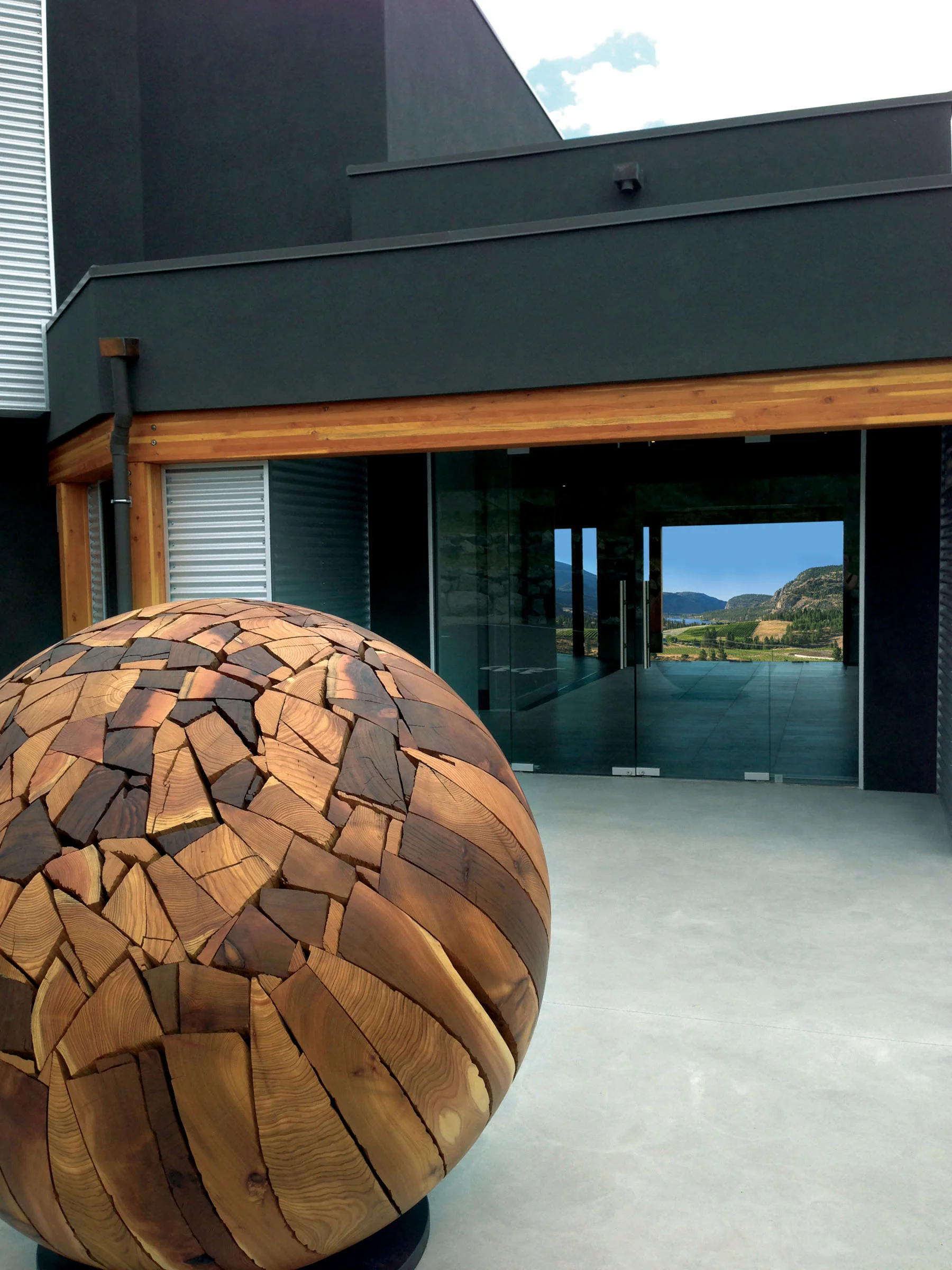 Shattered Sphere, by sculptor Brent Comber, greets visitors at the entrance to the mail building