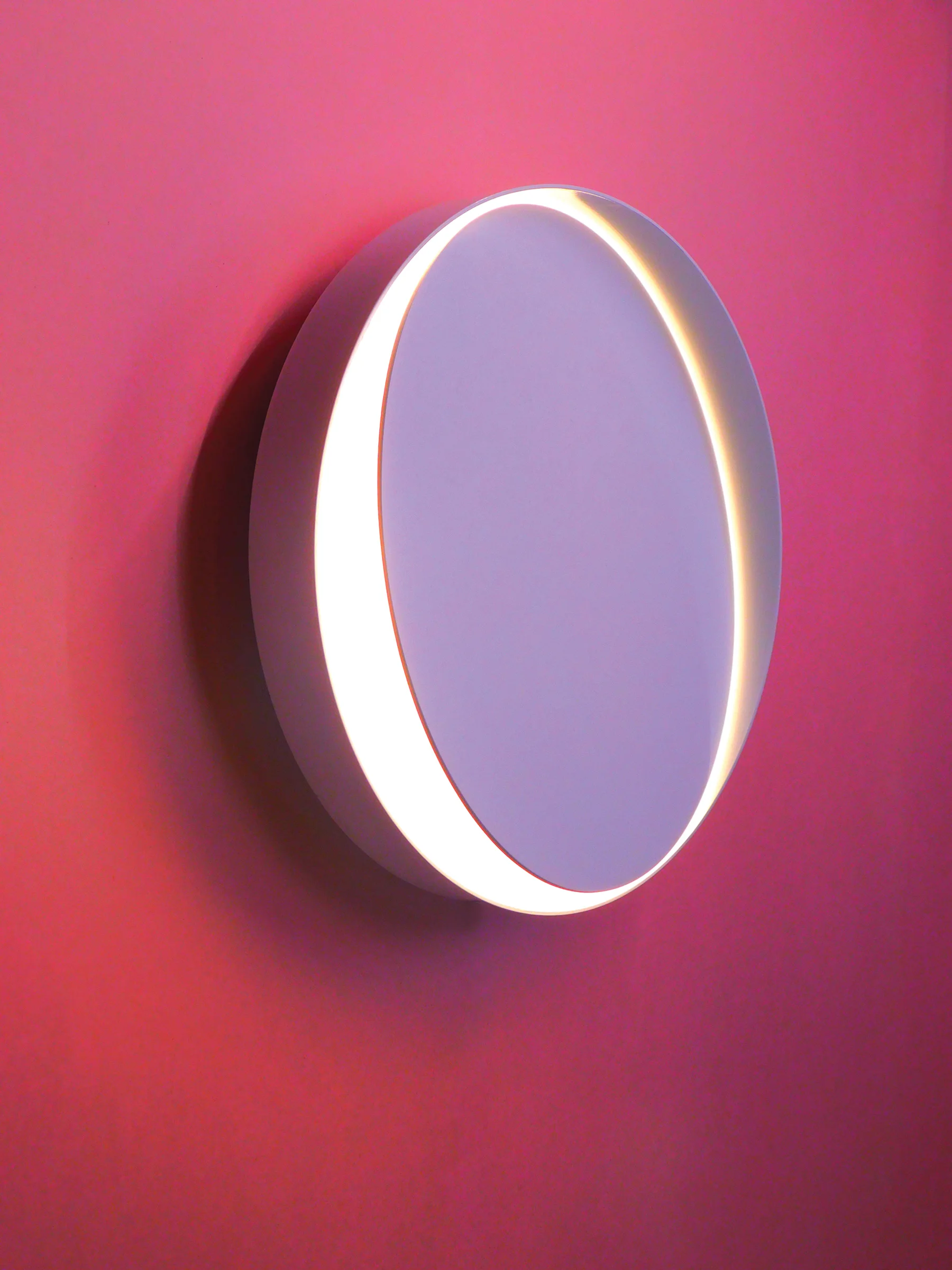 The Horizon wall sconce, by Anony- a minimalist disk with an unbroken ring