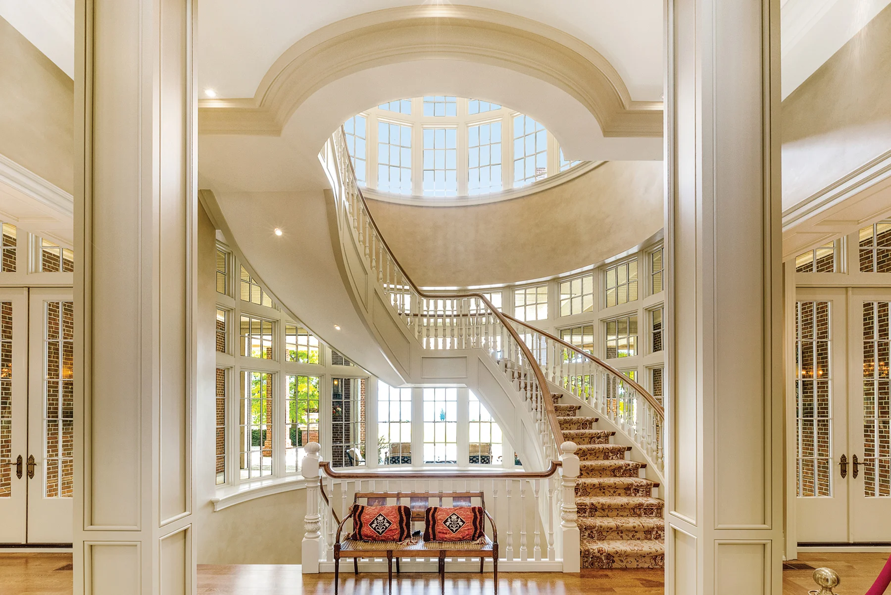 Expansive windows & magnificent domed glass ceilings allow natural light to stream into the foyer