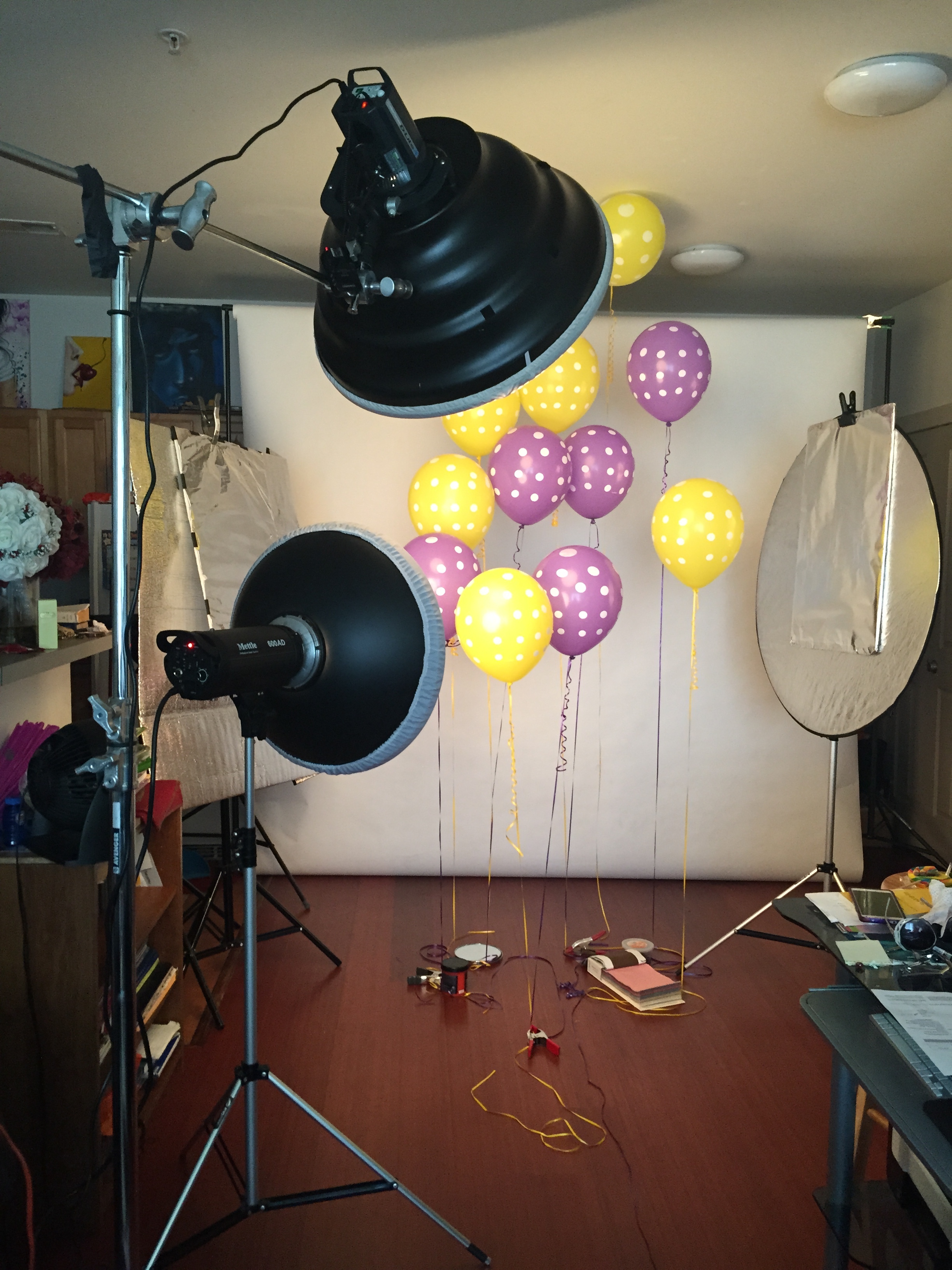 Getting ready for the shoot, using some A clamps to hold down the balloons. 