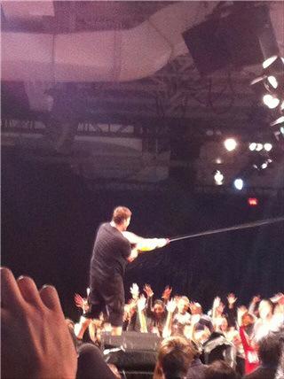 It was so hot from all of the energy circulating the room he pulled out a water gun and begun so shower everyone in the audience.