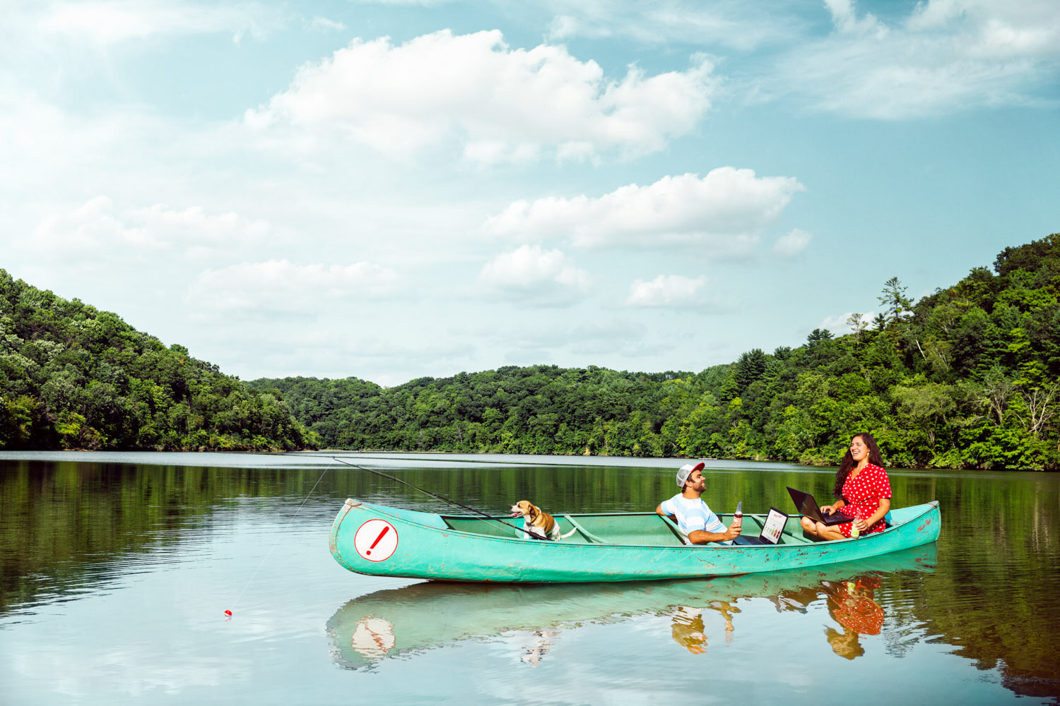 Commercial portrait photography: business owners on Jersey Valley Lake in a canoe with their dog for advertising campaign for Vernon Communications Coop