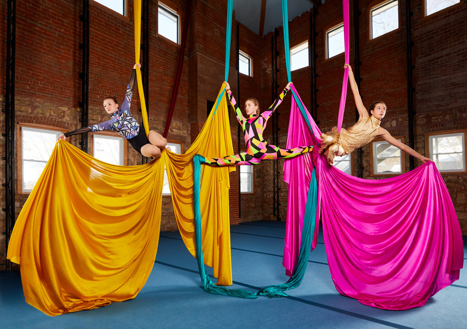 promotional photos for Bricolage Cirkus aerial performers on colorful silks