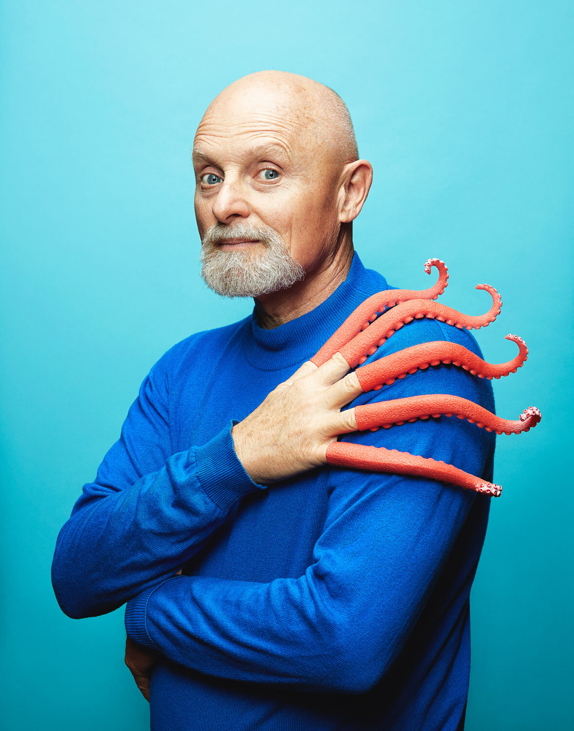 silly portrait of composer William Neil wearing octopus tentacles on his fingers by portrait photographer Hanna Agar