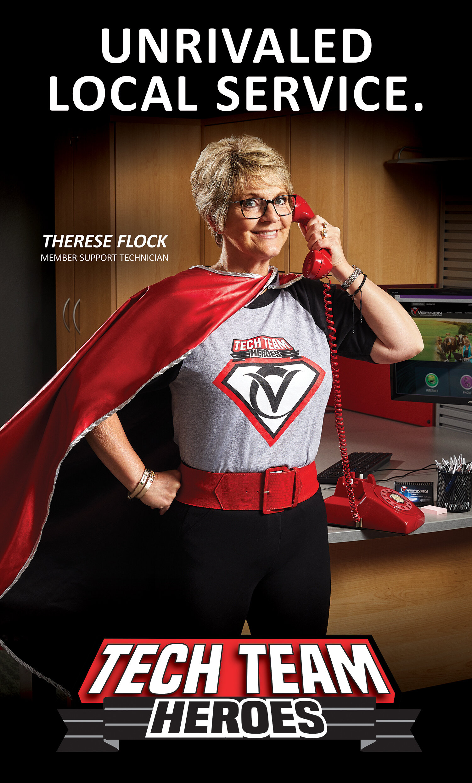 Commercial portrait photography: Employee in superhero cape in an office for advertising campaign for Vernon Communications Coop in Westby, WI.