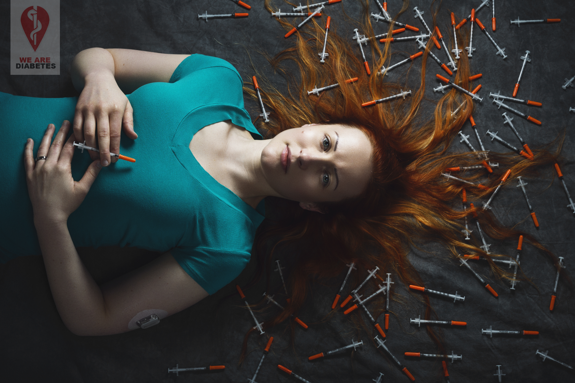 conceptual portrait for non-profit We Are Diabetes of founder Asha Brown laying surrounded by insulin needles.