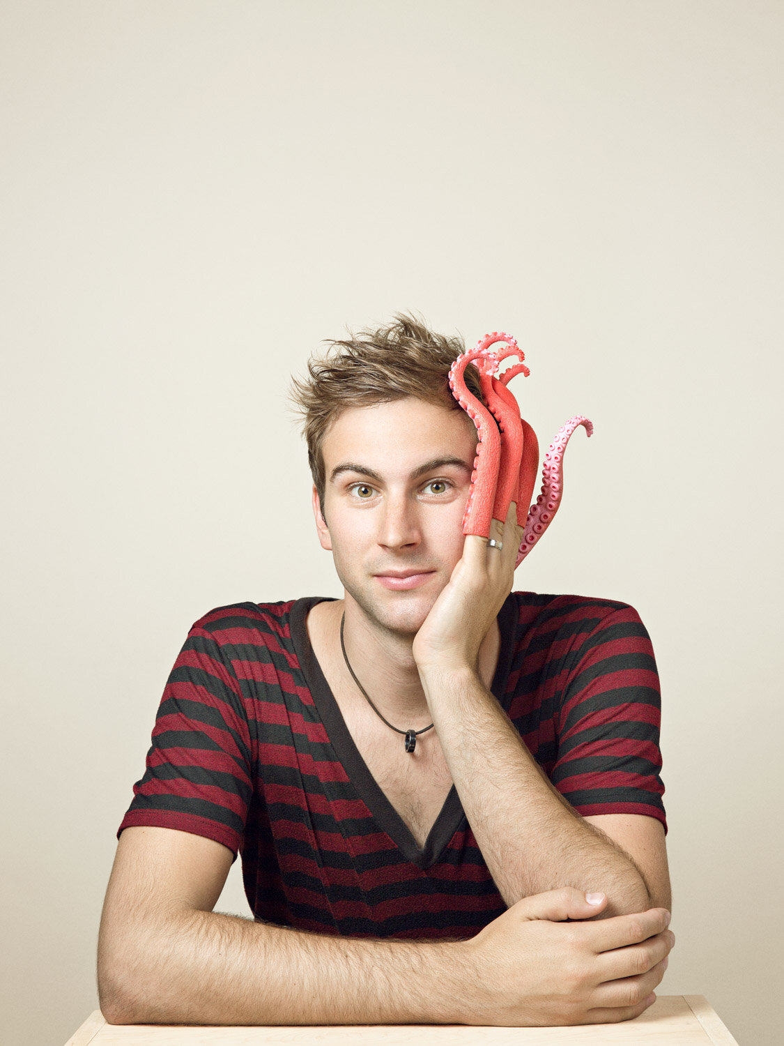 quirky portrait of juggler Marcus Monroe with octopus tentacle hand by studio portrait photographer Hanna Agar