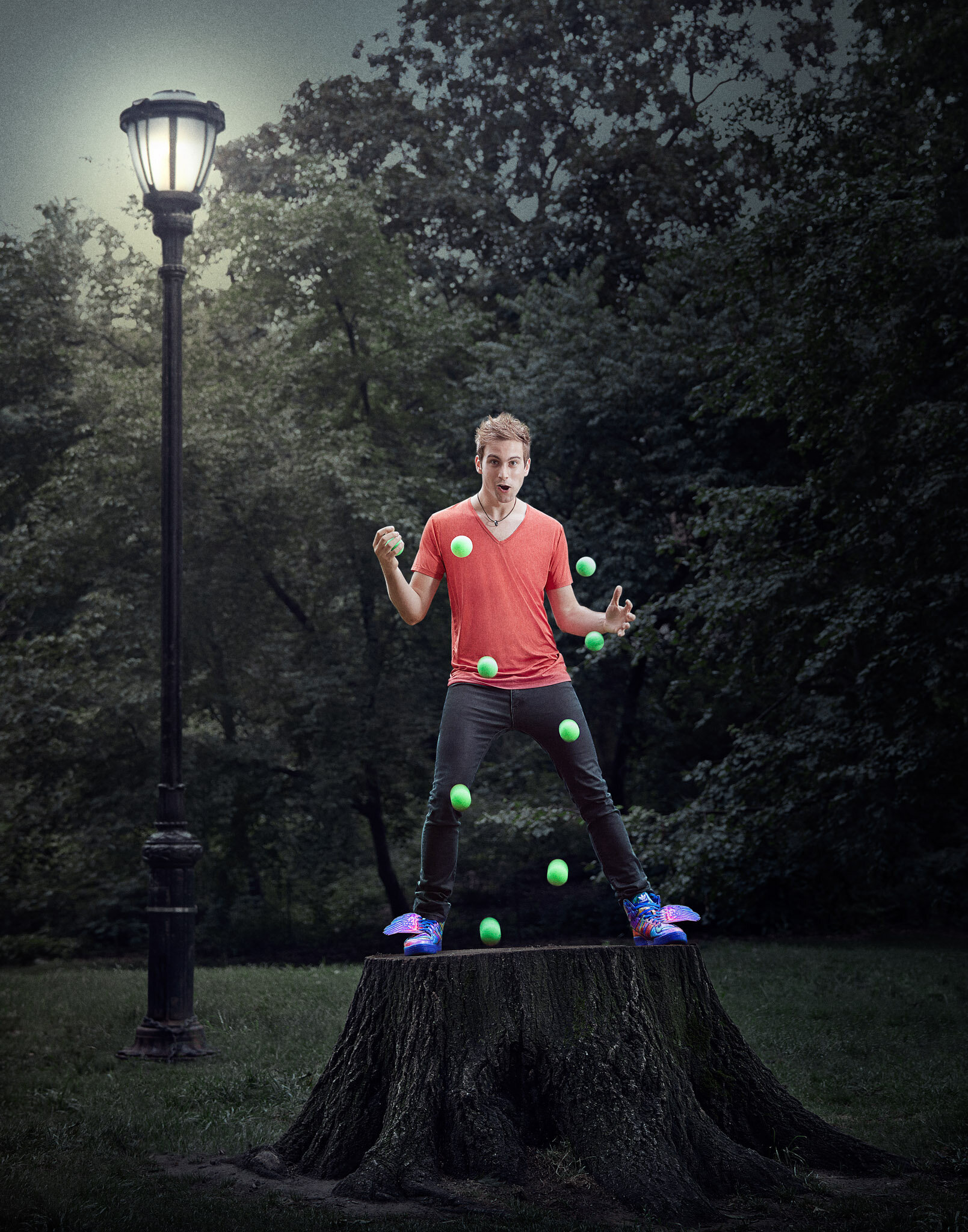 promo photo of juggler Marcus Monroe bounce juggling on large tree stump in Prospect Park, NY portrait photographer Hanna Agar