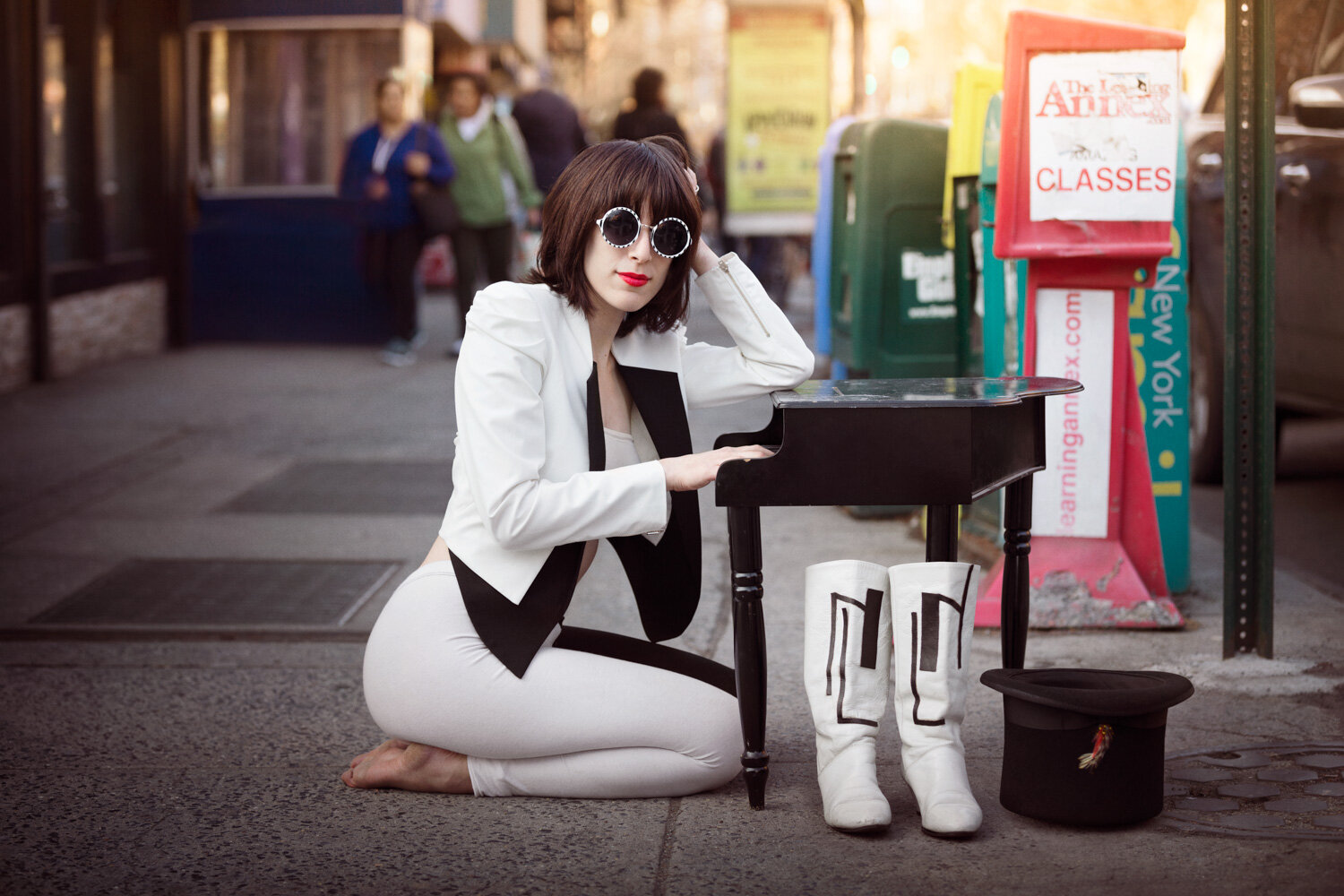 whimsical musician portrait of  singer Janna Pelle playing a tiny piano on a Brooklyn, NY street by creative portrait photographer Hanna Agar