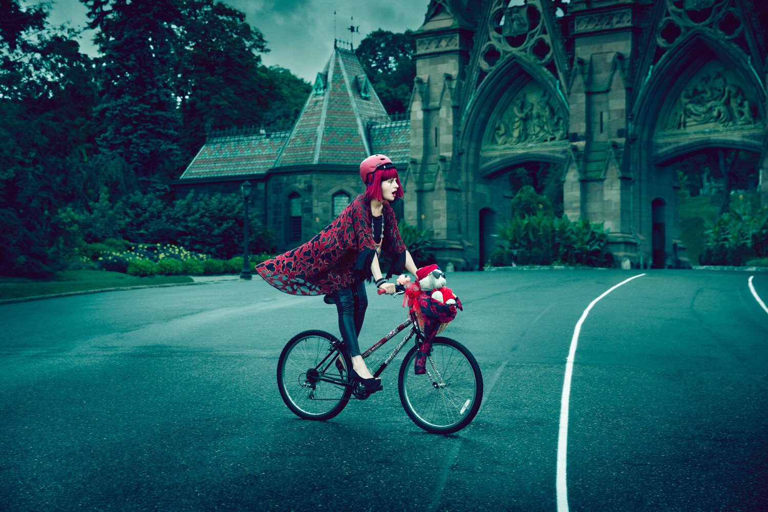 whimsical portrait of entertainer Michelle Joni wearing red and biking with teddy bear by artistic portrait photographer Hanna Agar