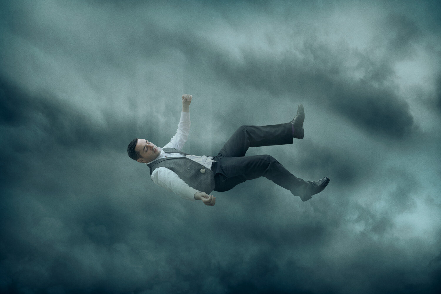 surreal portrait of singer in vintage outfit falling through clouds by conceptual portrait photographer Hanna Agar
