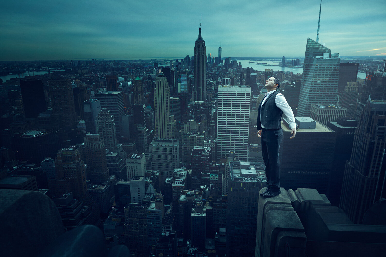 surreal portrait of singer standing on the edge of the Empire State Building by conceptual portrait photographer Hanna Agar