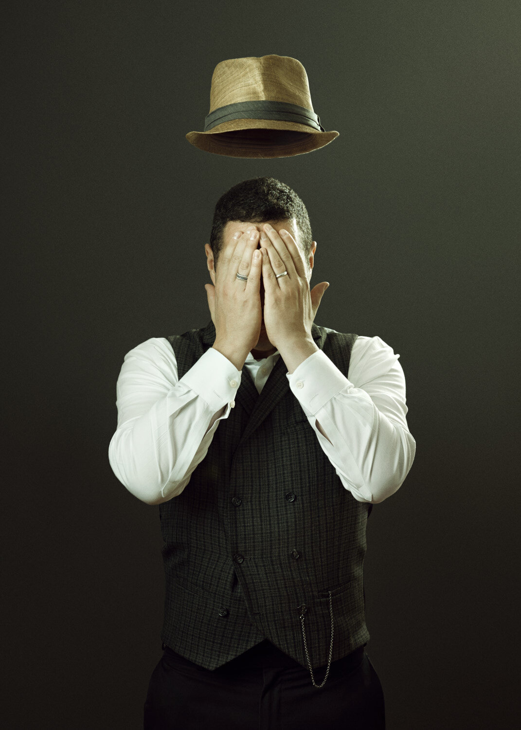 Magritte inspired surreal image of singer with floating hat by studio portrait photographer Hanna Agar