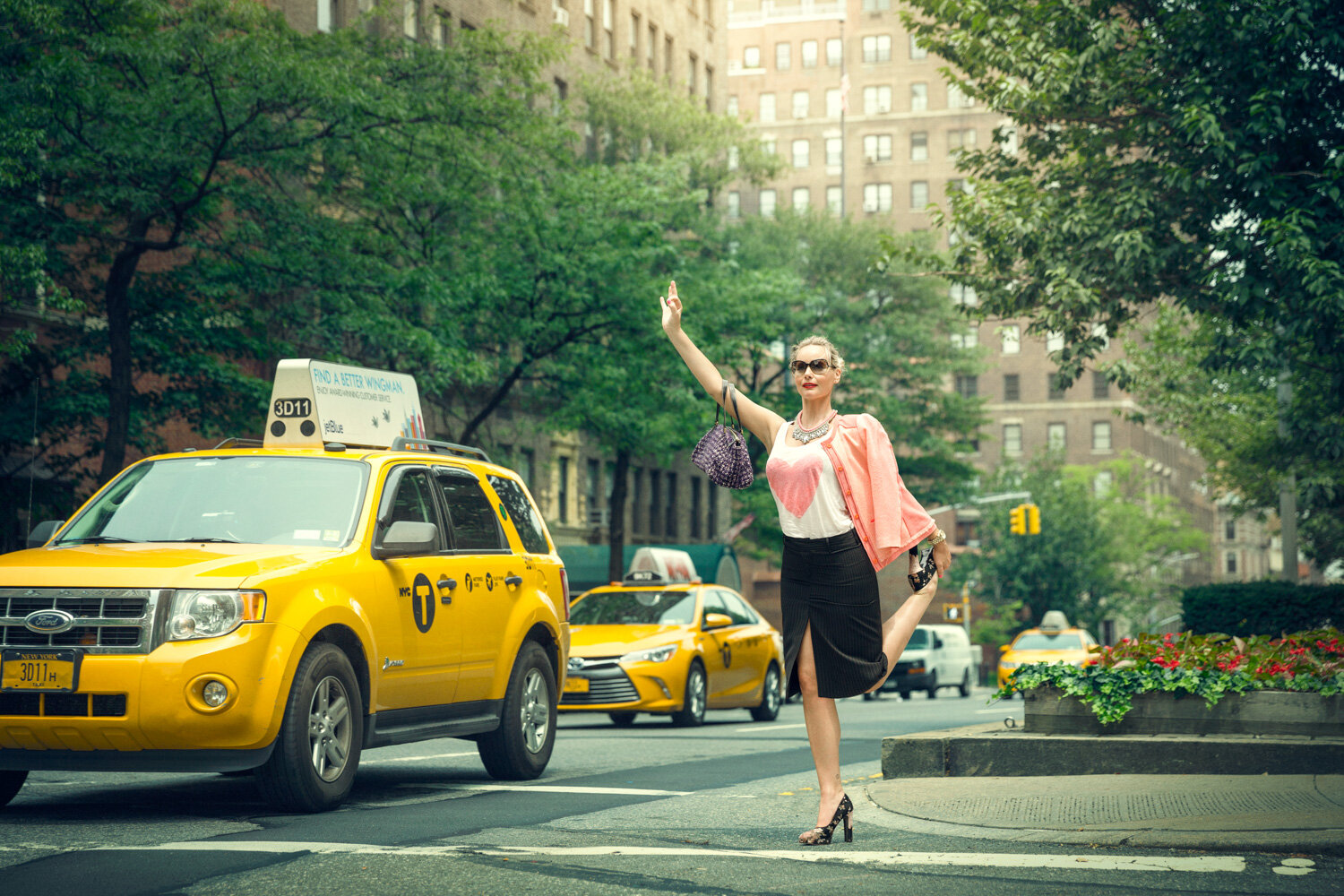 creative portrait of yogi Leila Johnson hailing a cab while standing in a yoga pose by conceptual portrait photographer Hanna Agar