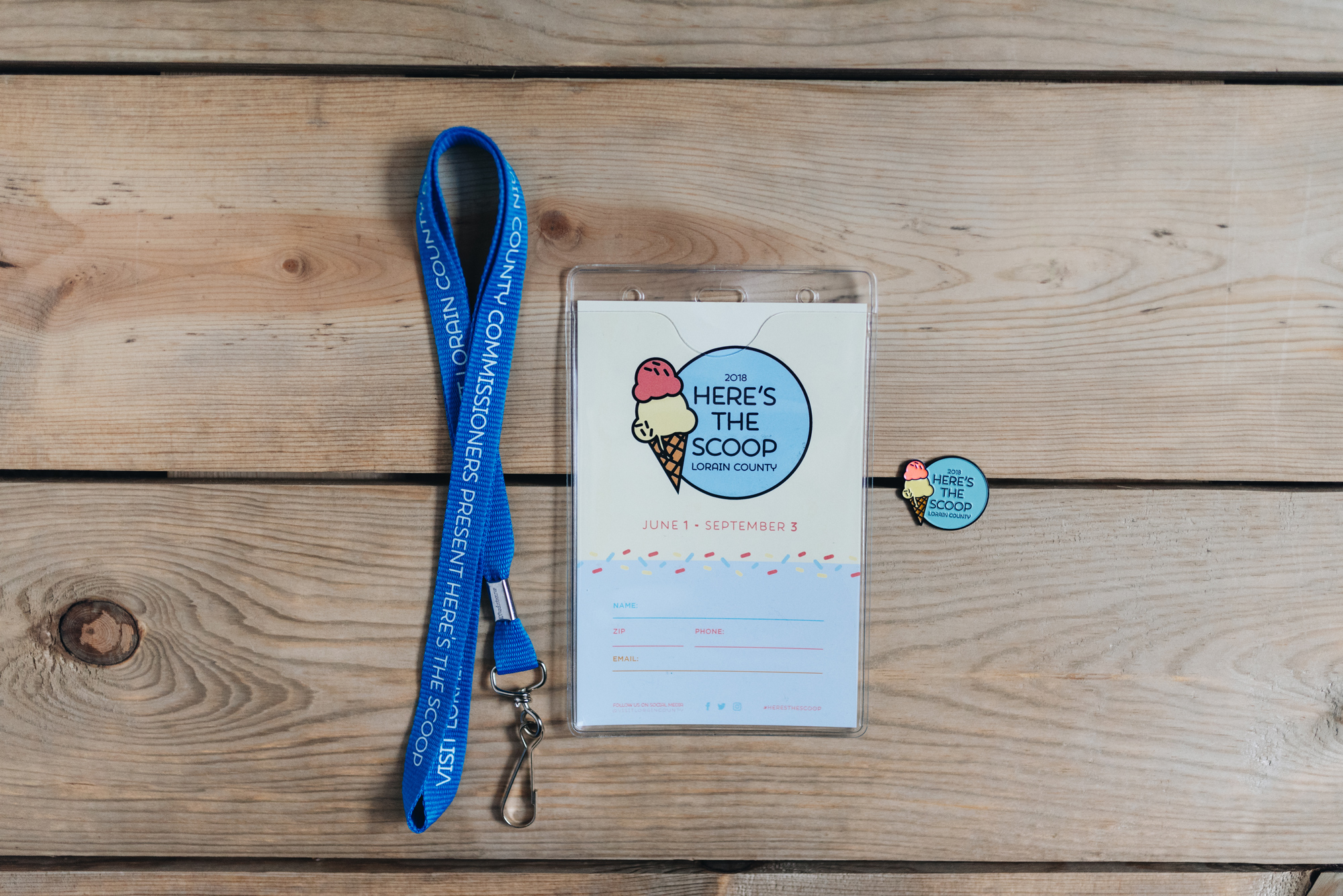 Flatlay of Here's The Scoop Passport and enamel pin || Photography by Me (Alex Lucas)