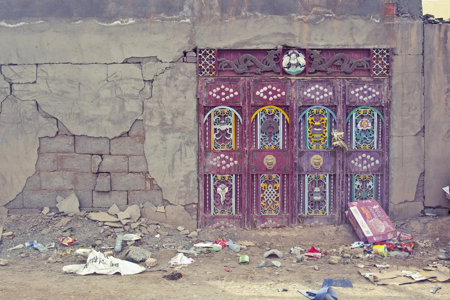 Qinghai, China, 2010  Monuments was photographed in a Tibetan region after an earthquake.  Most houses had collapsed, yet the doors remained standing—still carrying fragments of vivid colors, painted motifs, and traces of the Eight Auspicious Symbol