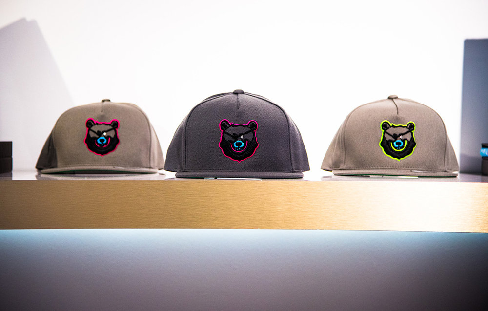  Snapbacks from the Launch Collection feature Bash the Pirate Bear. &nbsp;A gradation of grey caps stitched with 3D embroidery in contrasting pink and neon colors. &nbsp;Edition of 100, number stitched on the inside.  Shop. 