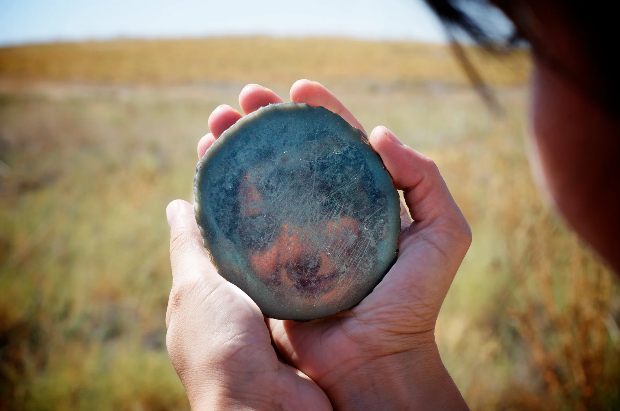 Banu Aydınoğlugil demonstrates an obsidian mirror excavated in 2012, Çatalhöyük, Turkey.