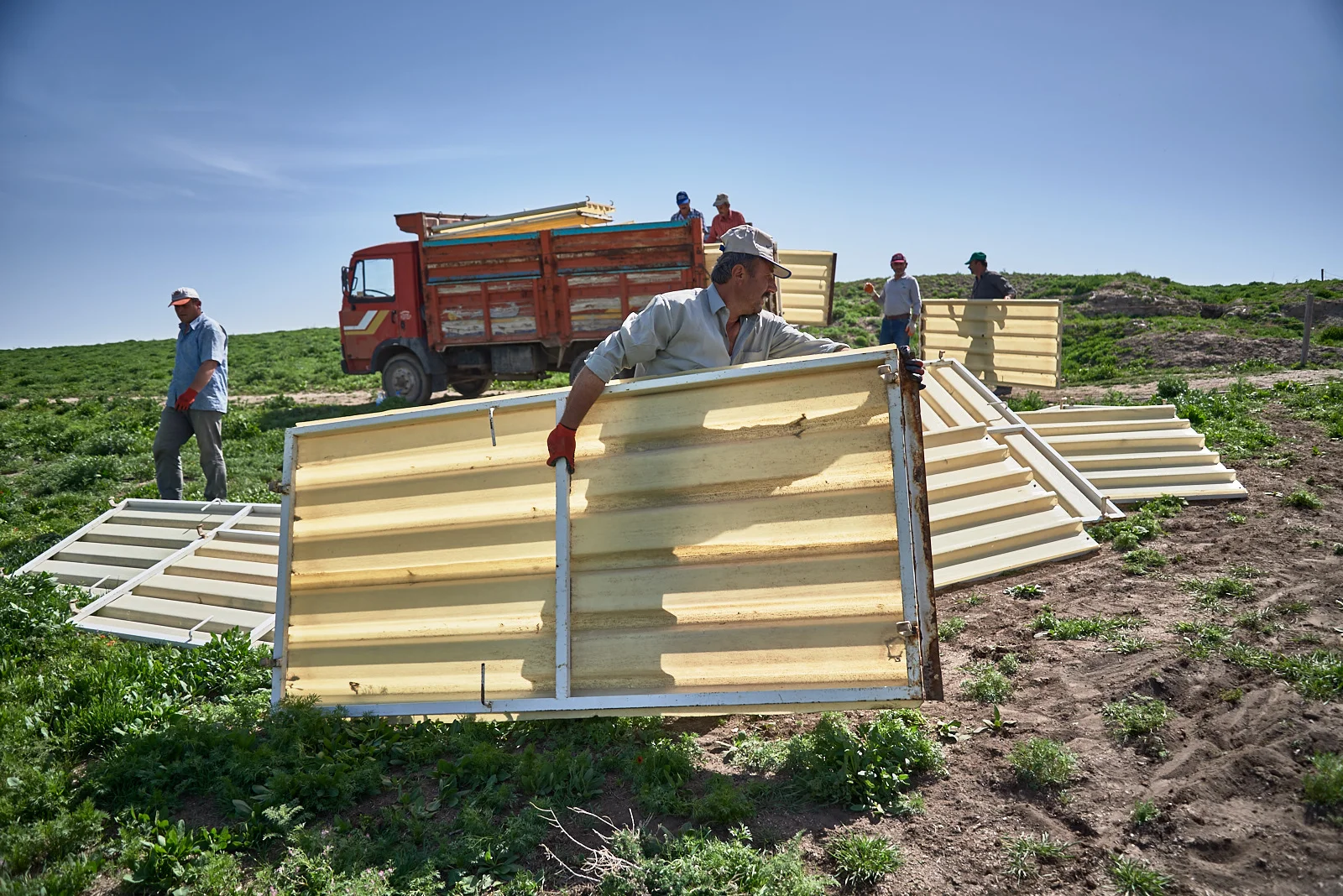 Workers haul away side panels removed from the South Shelter.