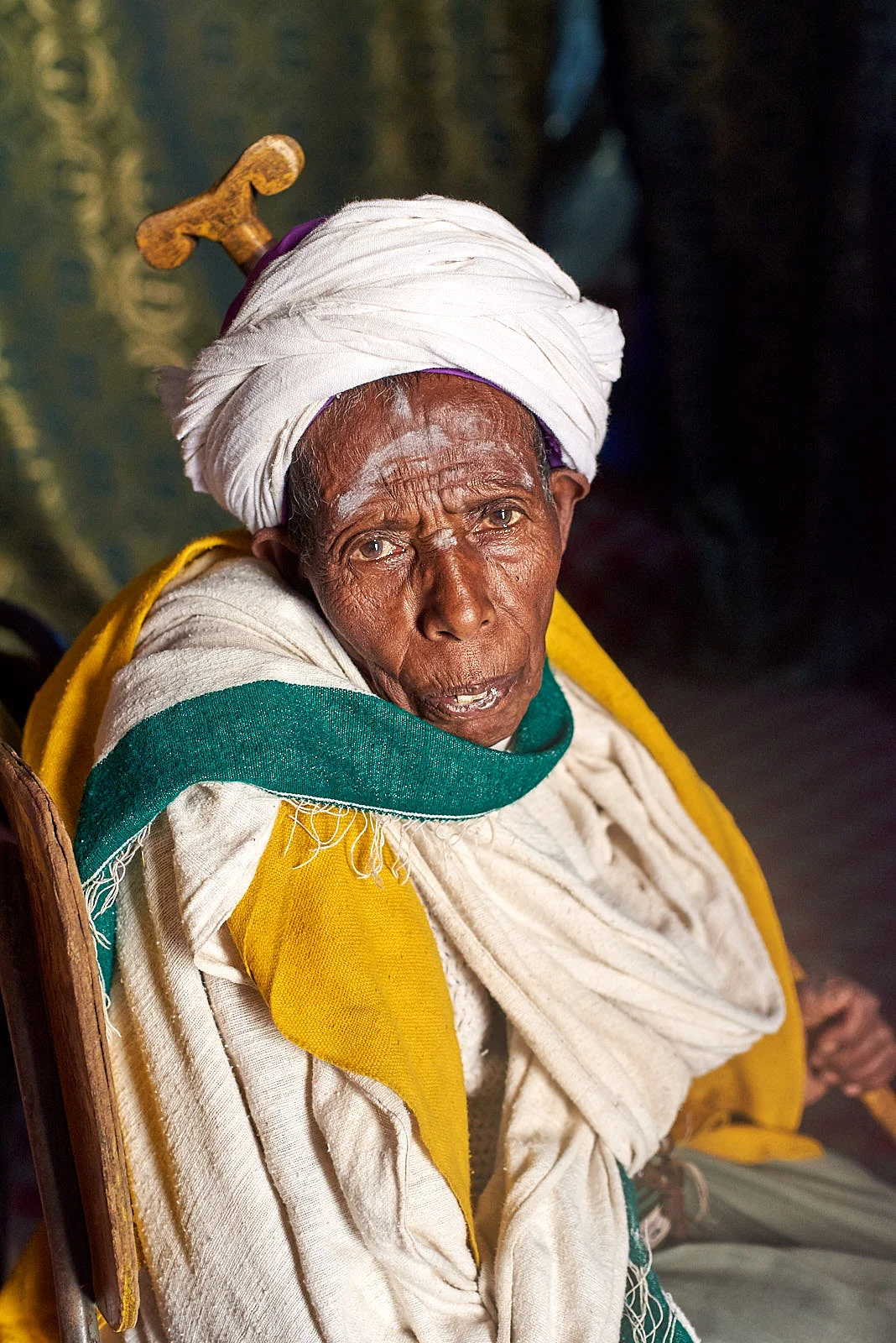 Ethiopian Orthodox priest on pilgrimage rests after prayers inside the Church of Saint George, Lalibela, Ethiopia.