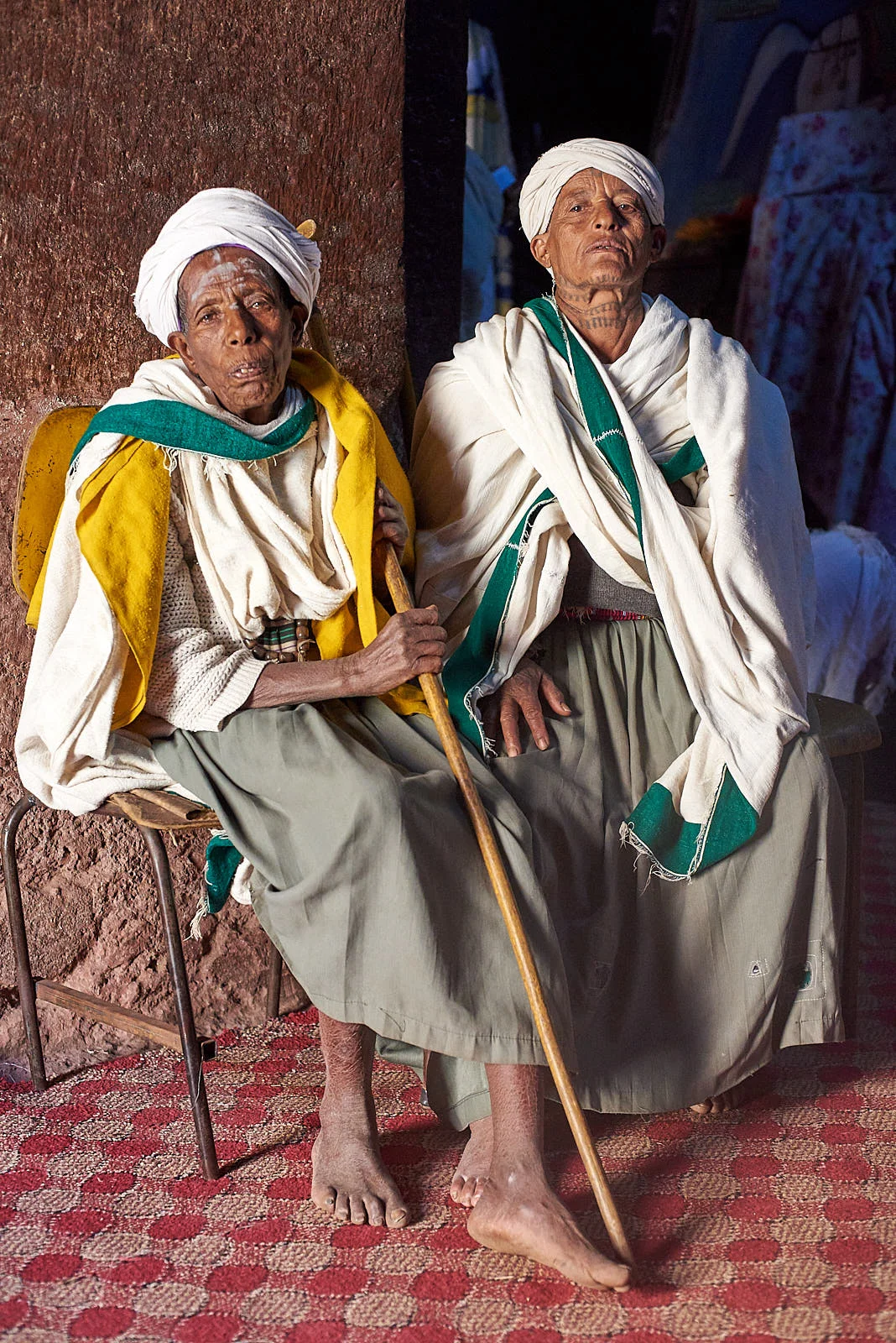 An Ethiopian Orthodox priest and pilgrim rest together after praying inside the Church of Saint George, Lalibela, Ethiopia.