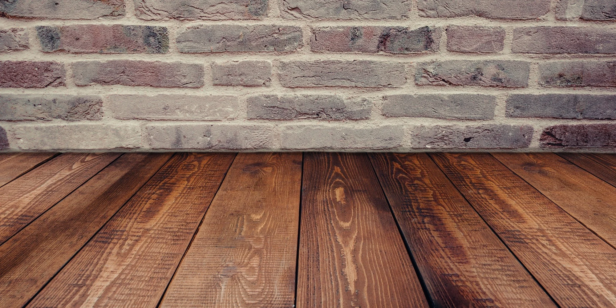 It is an interesting philosophical question: if something looks like, feels like, and acts like something else, does it matter if it is not technically the other thing? In the case of flooring, it is a debate being played out on the floors of homes and businesses across the country. Luxury vinyl plank flooring is a hot building material these days because of the ease with which it is installed and relative cheapness, combined with the fact that it looks an awful lot like the majority of hardwood flooring. Of course, some people still have preconceived notions about the nature of vinyl flooring, probably conjuring images from their youth of cracked plastic stick-on tiles. And since hardwood flooring has long been the standard when it comes to non-carpeted flooring options, it makes sense that many might be a little wary of the new kid on the block, so to speak. We here at Ozburn-Hessey believe in the positives and negatives of both materials, which is why we are happy to install either. Maybe you need a little bit more information about both of them, however, before making such a decision, which is why we put together this handy little primer. Vinyl? Sounds Good The main draw of using luxury vinyl plank flooring is the cost. It is cheap – a lot cheaper than pretty much every other type of flooring, except for maybe certain types of ceramic tiling. That might raise some red flags for some; after all, it must be cheap for a reason, right? Well, put your concerns about the quality of the material to bed, because these suckers are pretty tough. In some areas they are actually tougher than hardwood flooring. Vinyl plank flooring is almost 100 percent resistant to water, and handles most scratches and scuffs as well, making it perfect for a kitchen or bathroom. It also looks amazing these days, appearing almost exactly like hardwood. Stick With the Classics If luxury vinyl plank flooring is so much better than traditional hardwood flooring , then why would anyone go with anything else? Because there is a reason hardwood flooring is a classic. Vinyl plank flooring might look and feel a whole lot like hardwood flooring, but it will never actually be hardwood flooring. There is just something about the original that cannot be defeated. In this case it is the feeling underfoot of a wonderful handcrafted floor that just sets it apart. It is a more refined feeling, one that is often mimicked, but rarely duplicated. Yes, hardwood flooring installation is a little more expensive than vinyl plank, but on the flip side, it is a lot easier to remove, so if in the future you would like to change to something else, you do not need to worry about it. As with many things in life, there is not really a clear cut answer when it comes to deciding whether luxury vinyl plank flooring is better than traditional hardwoods. Luckily, both come in a number of colors and styles, so you will find the floor that perfectly suits you, and the professionals here at Ozburn-Hessey will be there to assist you every step of the way.