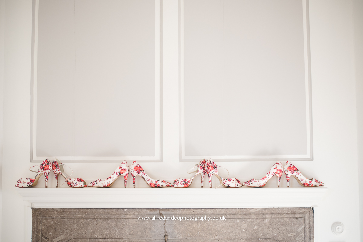 flowery shoes on fire place