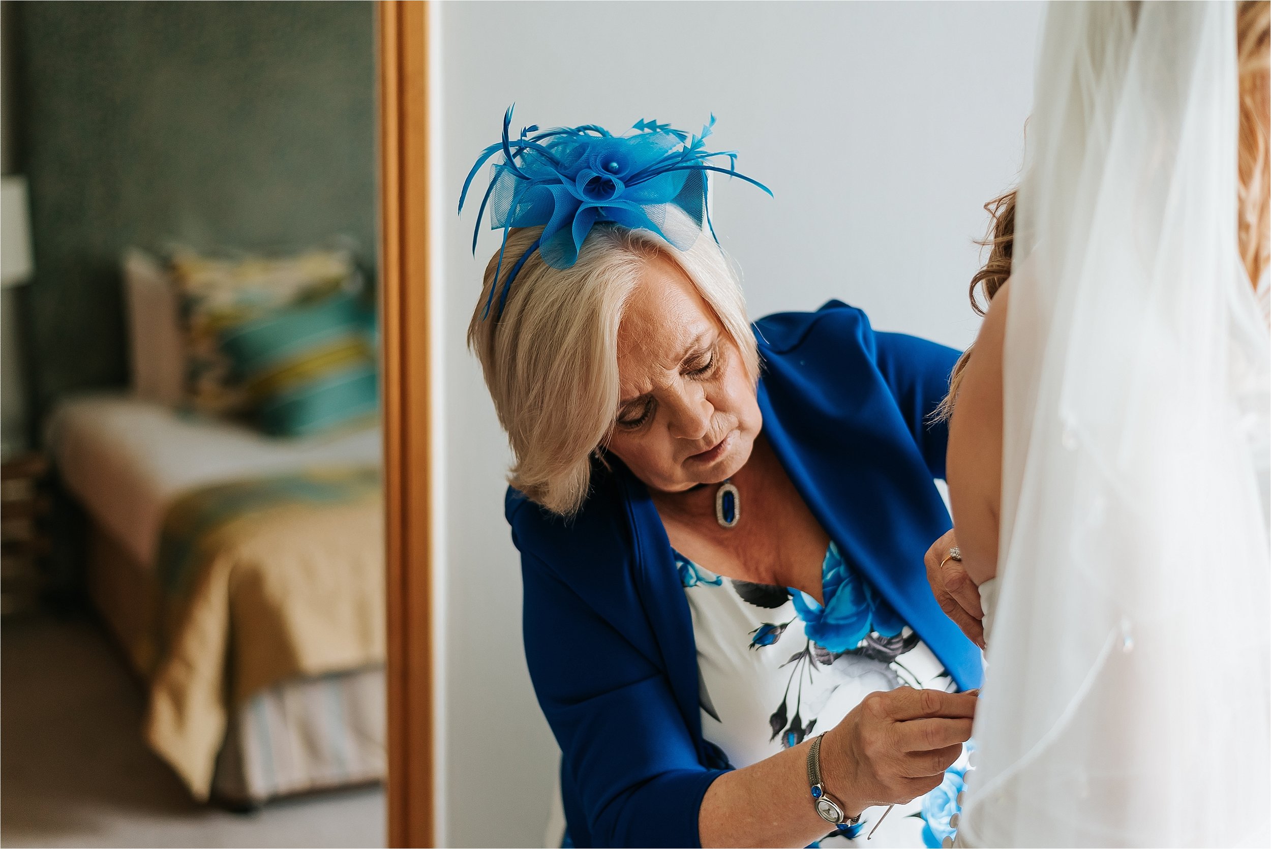 mum helping bride get ready