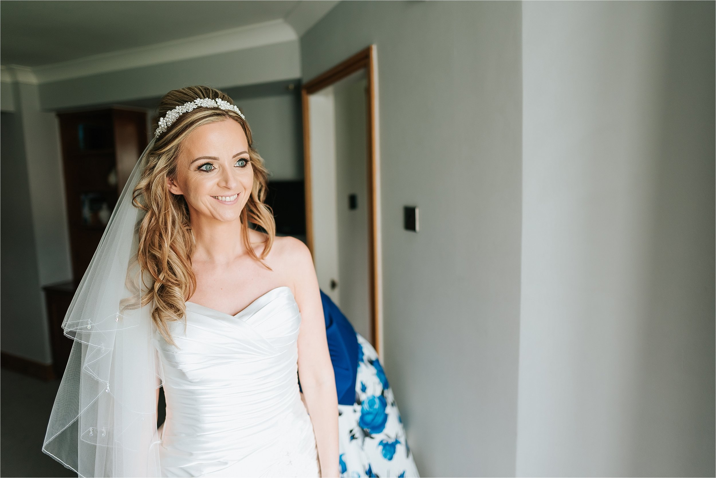 bride looking out of the window at wedding