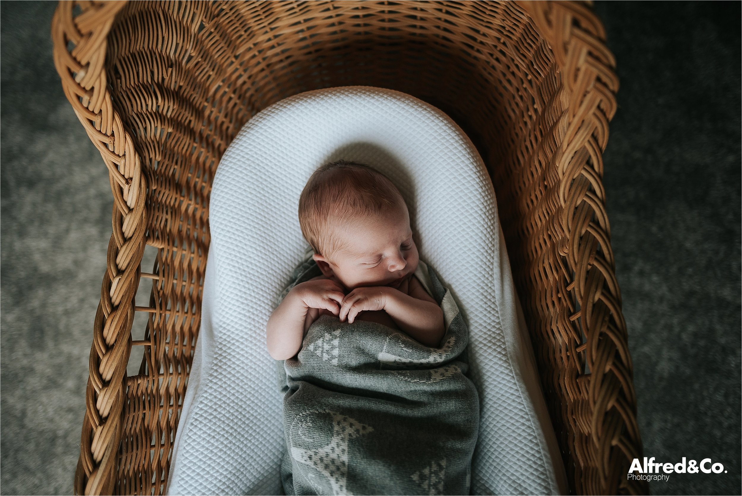 baby boy in wicker moses basket 