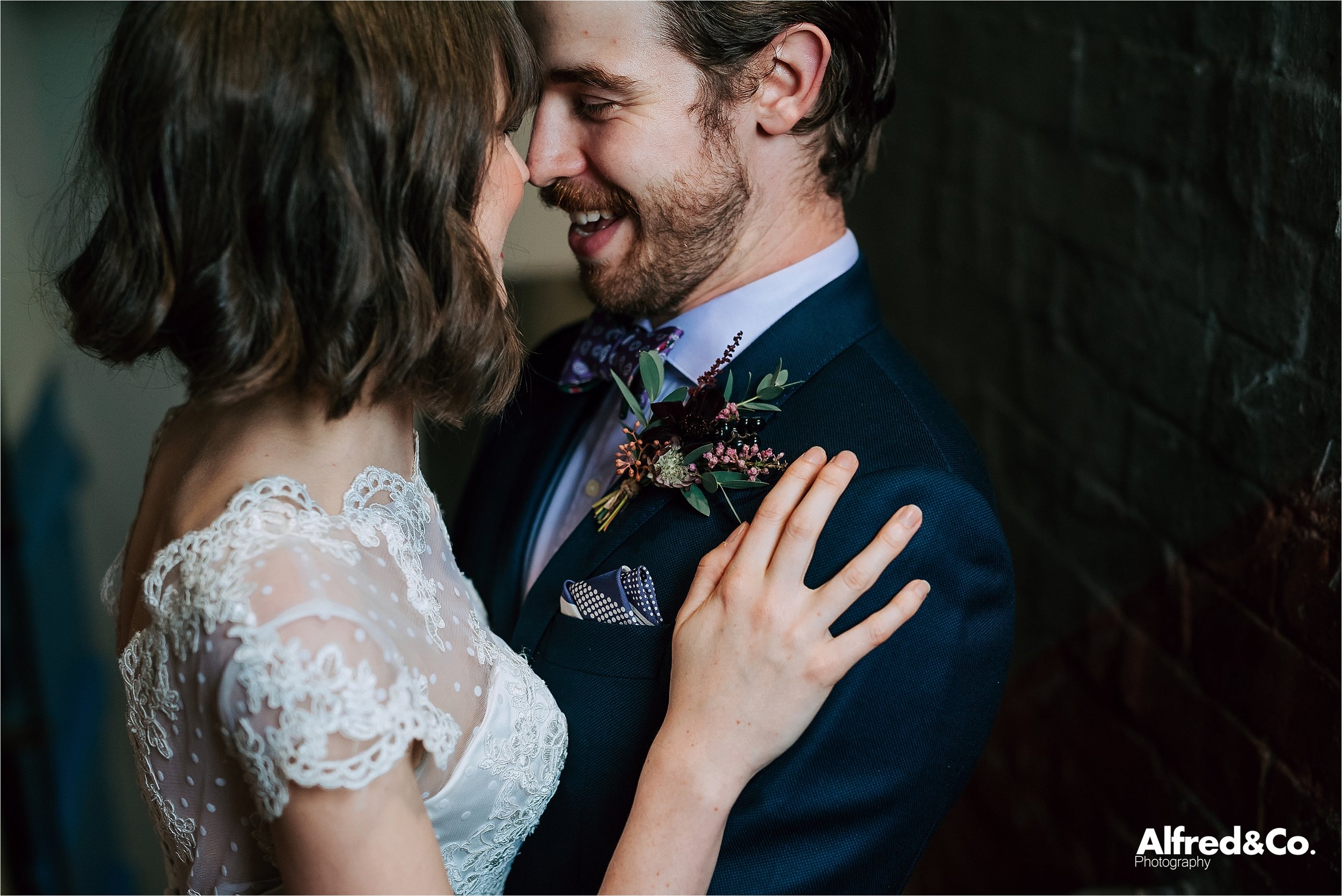 cute couple in rustic wedding venue 