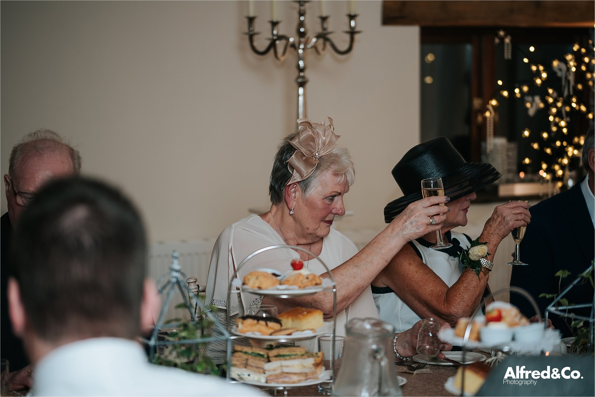lady toasting with champagne at wedding at beeston manor