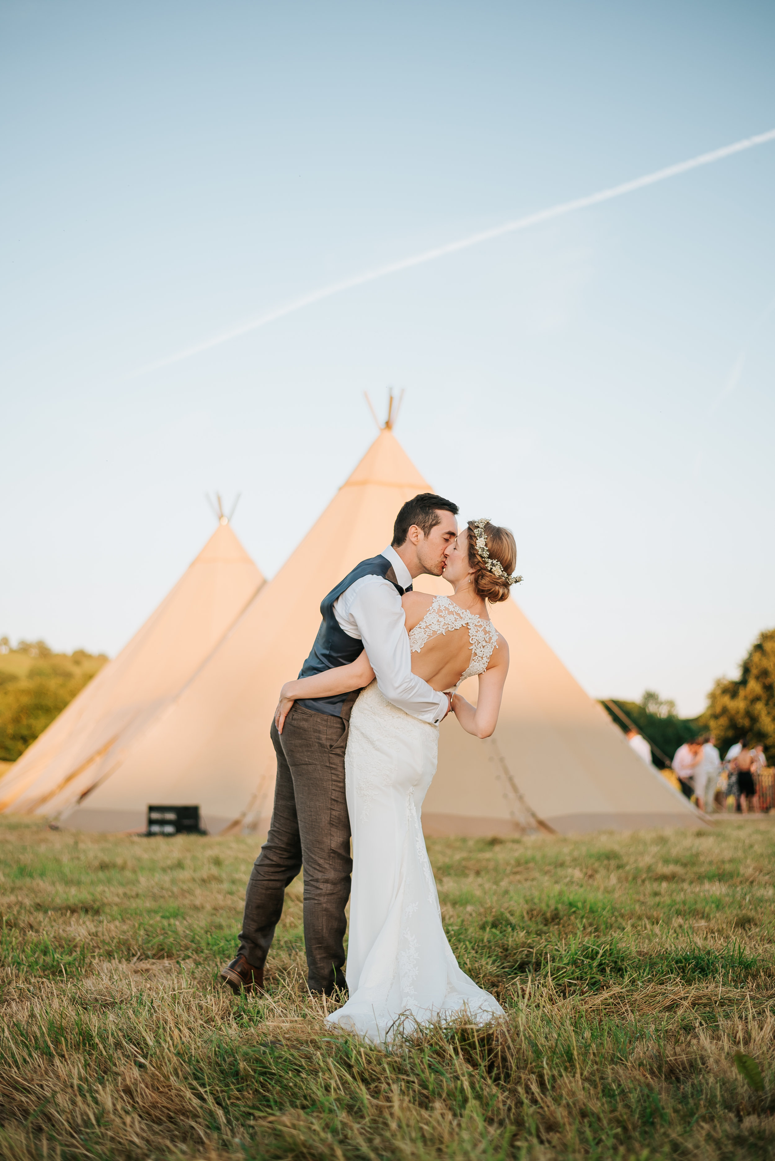 bride and groom in a field 