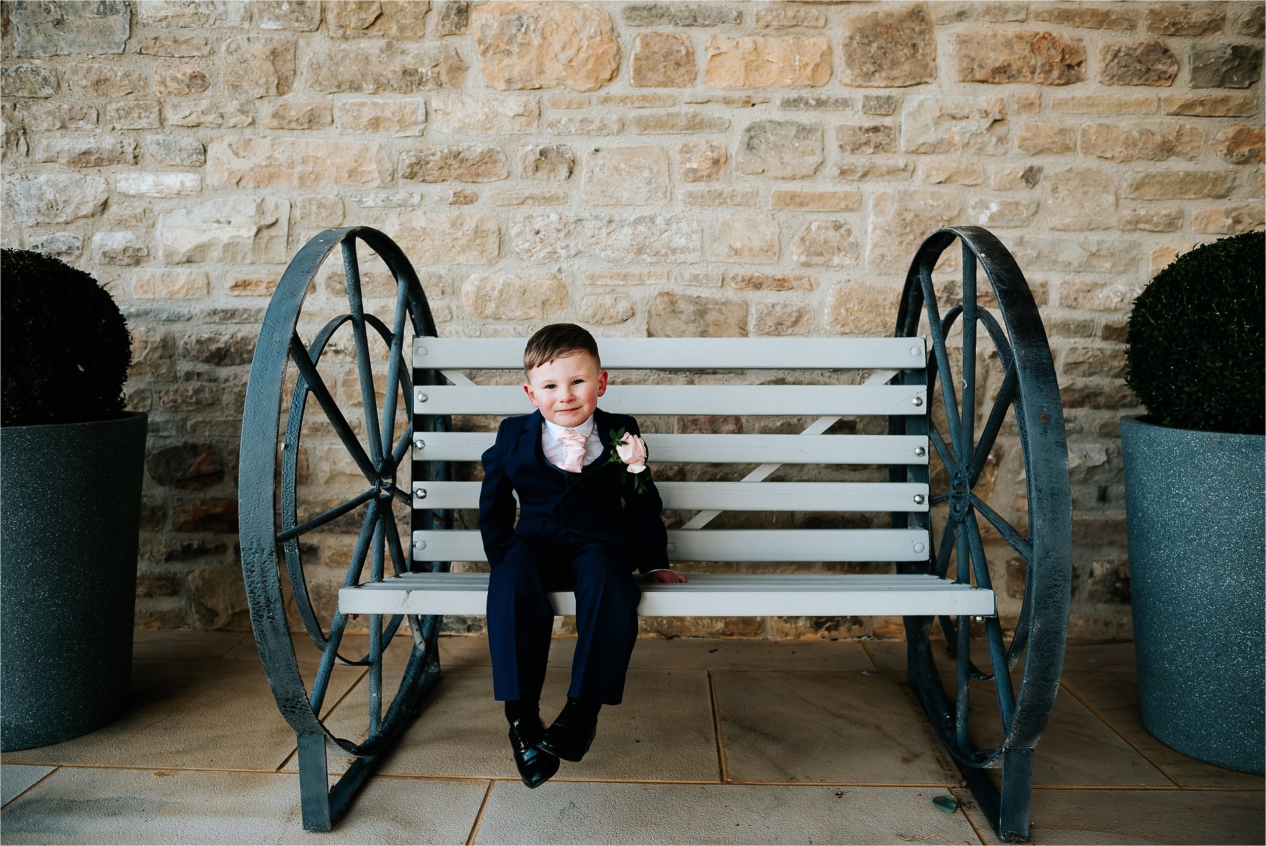 boy sitting down at wedding 