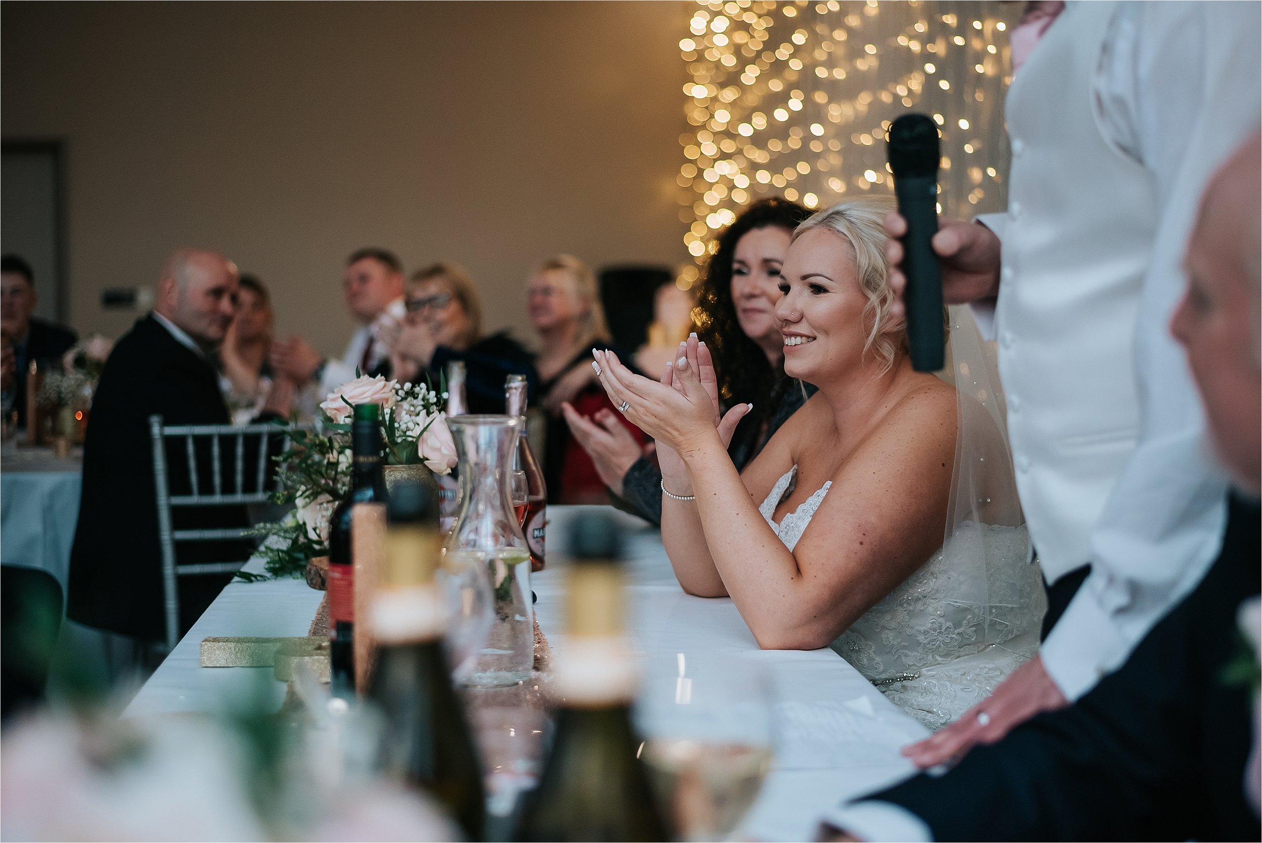 bride clapping at wedding speeches 