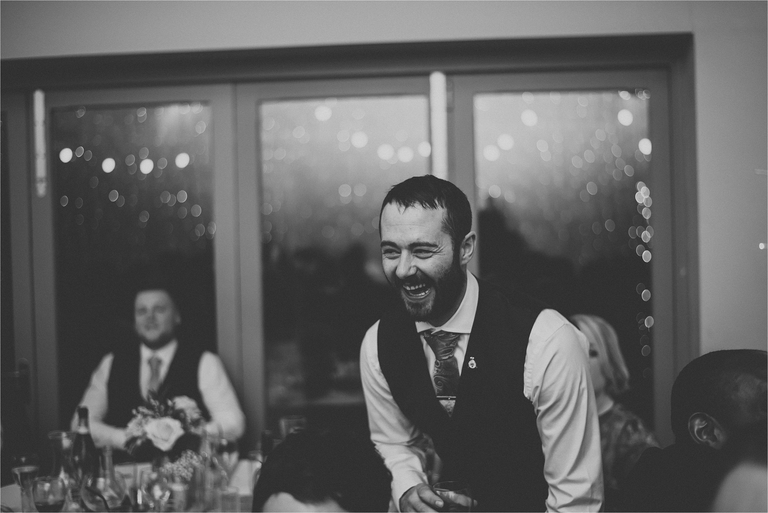 man laughing at wedding party 