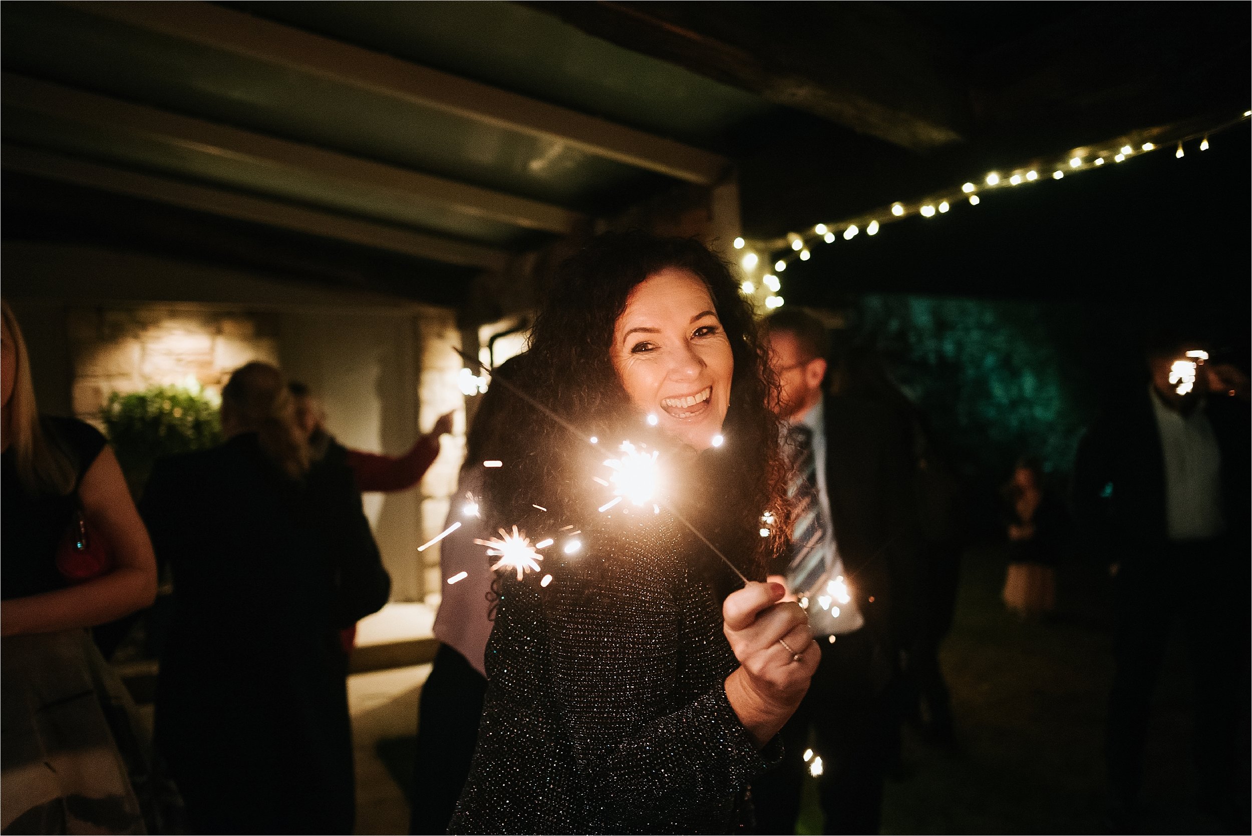 playing with sparklers at wedding 