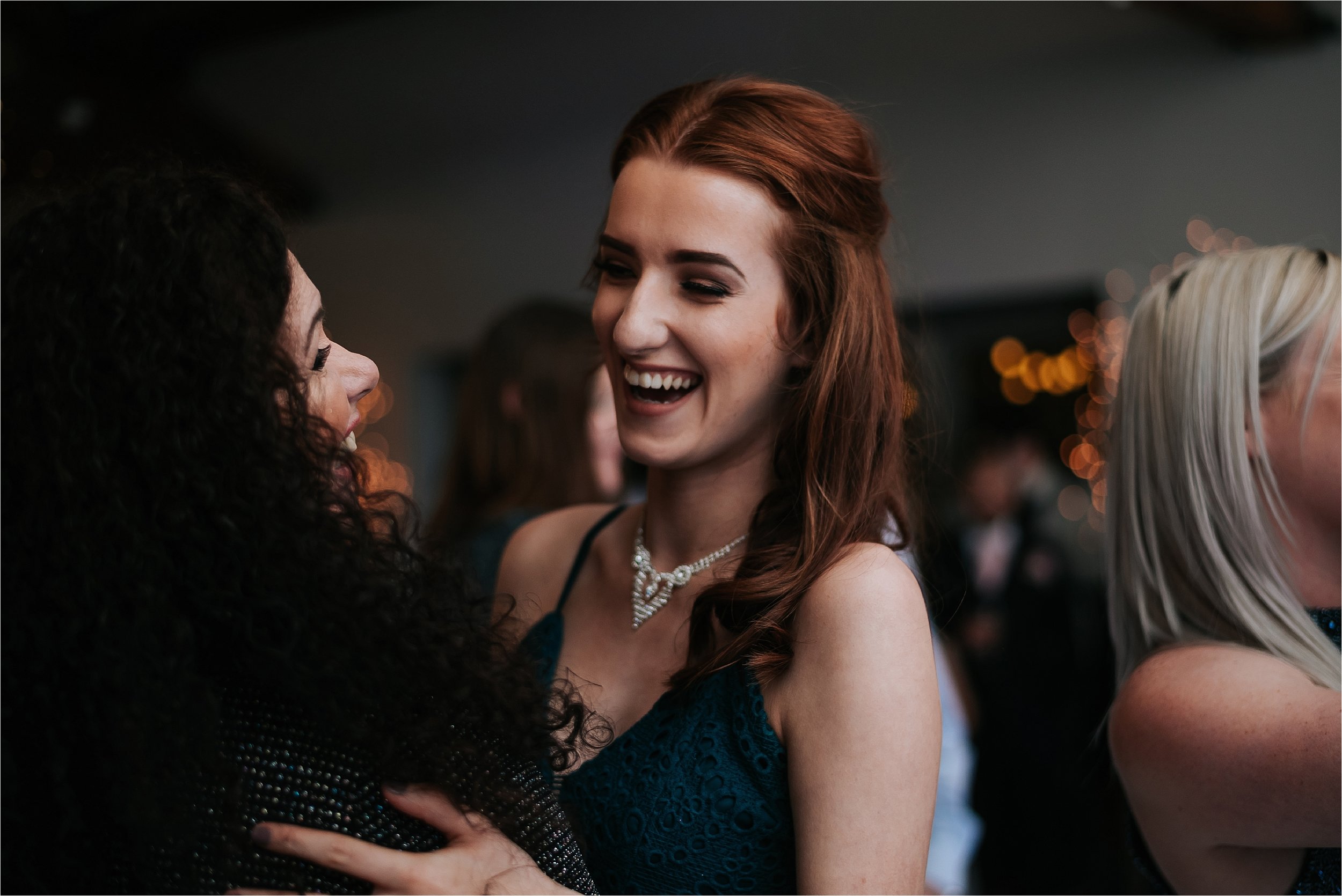 woman laughing at wedding reception 